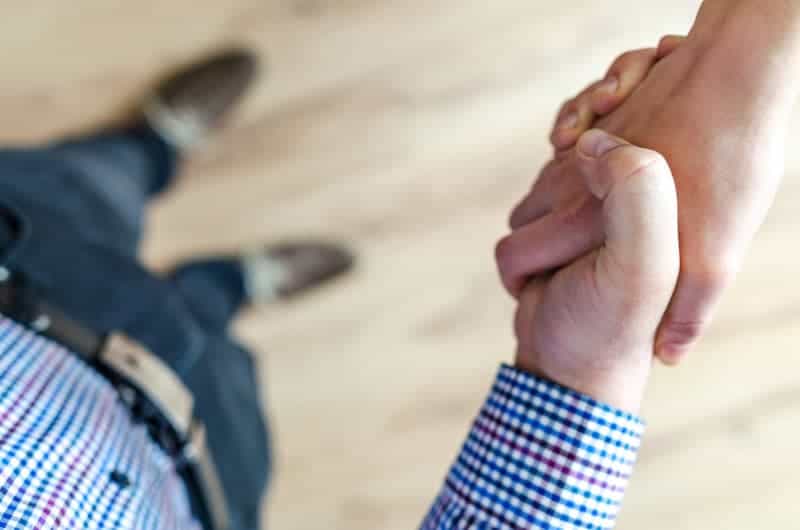 Two people shaking hands from a bird's eye view