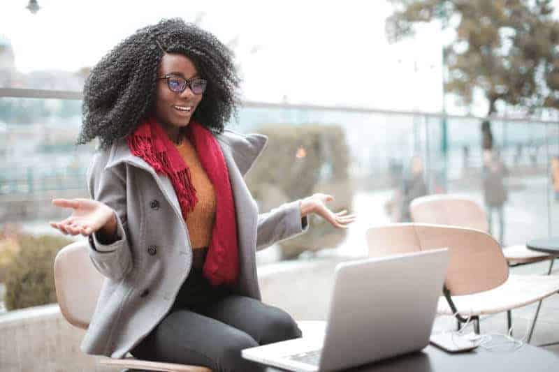 Cheerful Surprised Woman Thrilled woman reacts to good news from her laptop