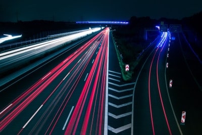 Time lapse of accelerating car lights on a highway