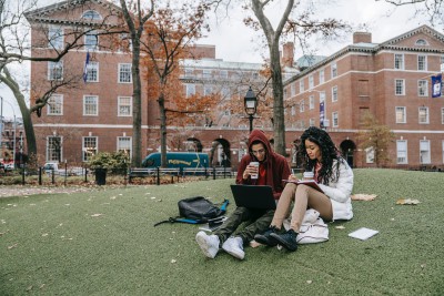 Two college students picnicking on campus grounds