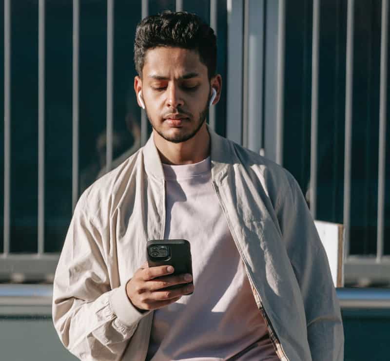 Man checks his phone while outside