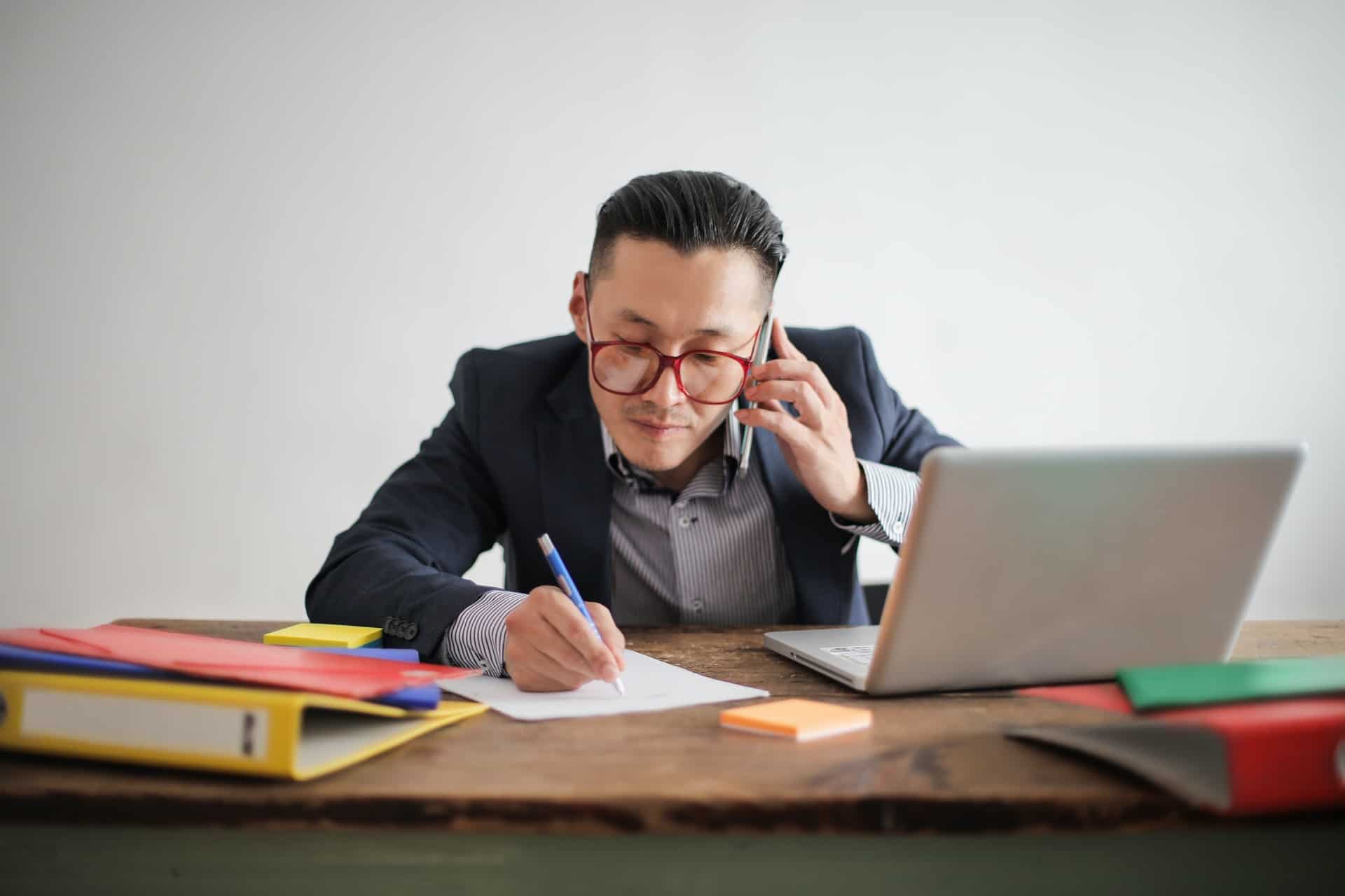 Adapting to Best Practices Business Man on Phone and Laptop