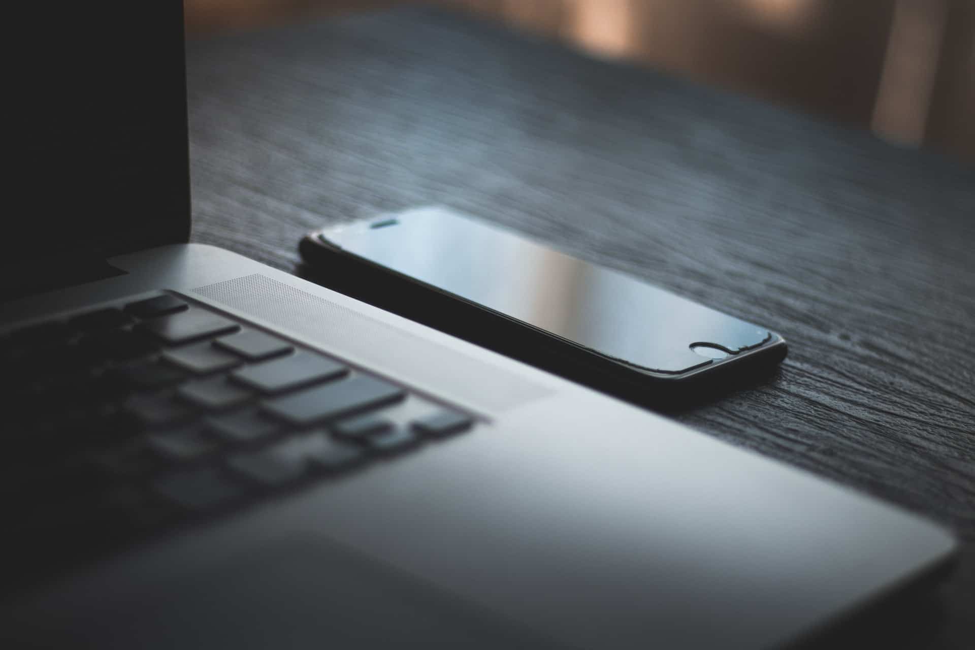 Laptop + Cell Phone on desk