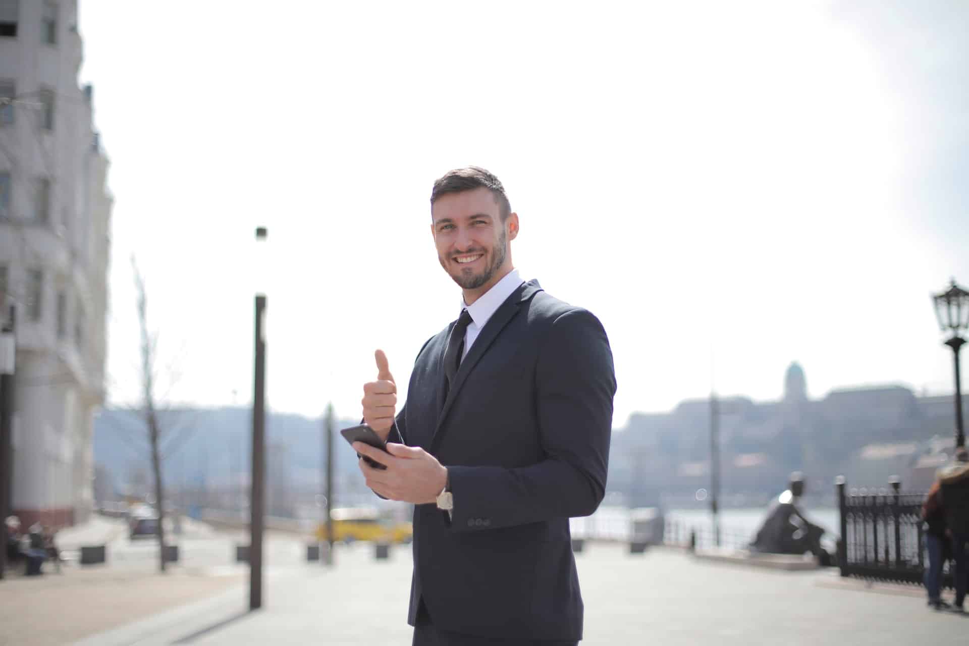 Businessman smiling and giving the camera a "thumbs up"
